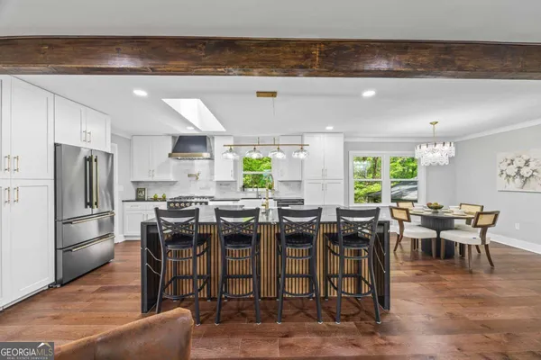 a kitchen with stainless steel appliances granite countertop a sink stove and refrigerator