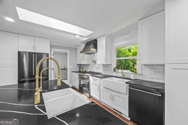 a kitchen with stainless steel appliances granite countertop a refrigerator and a stove top oven