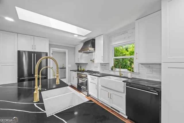 a kitchen with stainless steel appliances granite countertop a refrigerator and a stove top oven