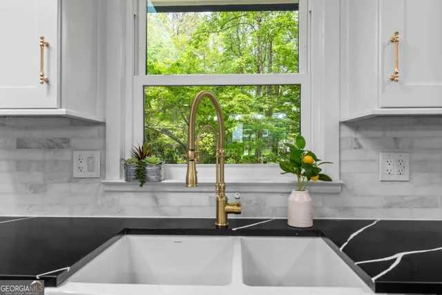 a kitchen with a refrigerator and a stove top oven