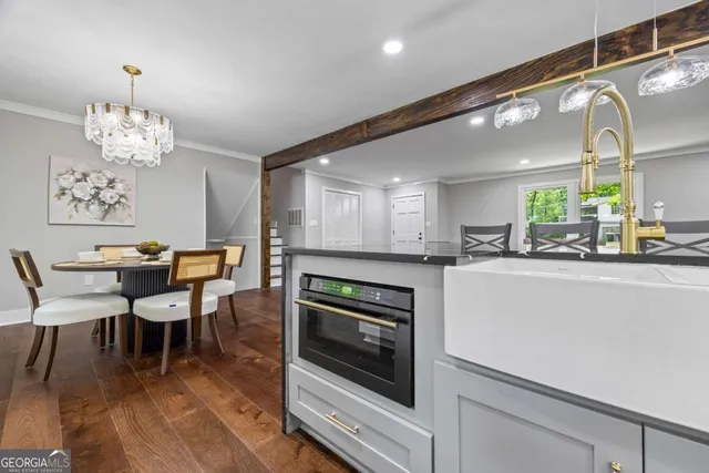a kitchen with granite countertop a stove a sink and a refrigerator