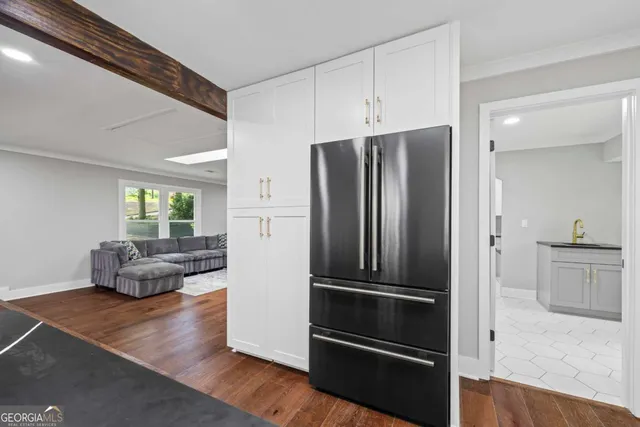 a view of staircase with white walls and a rug