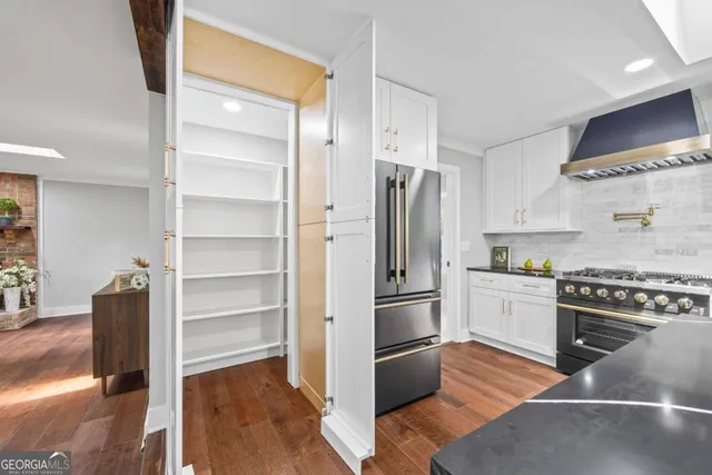 a bathroom with a granite countertop sink a toilet and shower