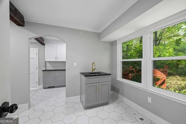 an empty room with wooden floor and a window