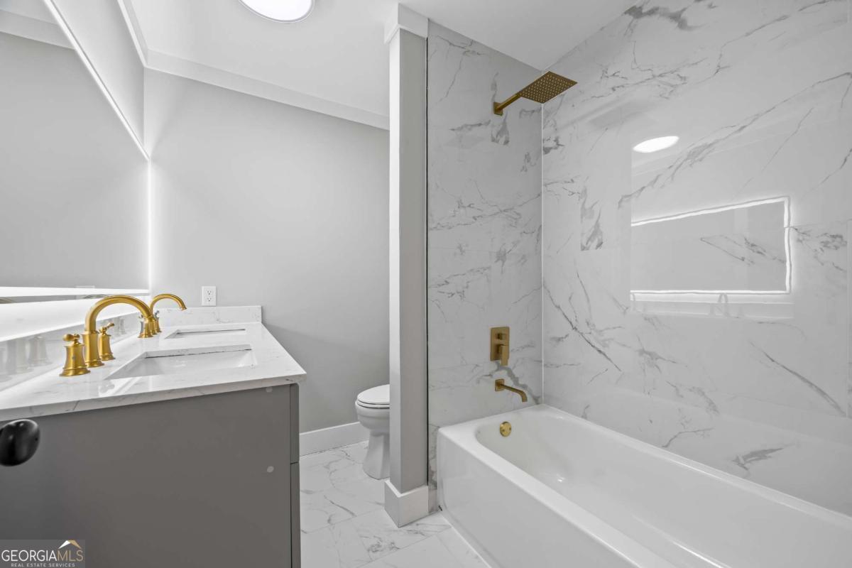 125 Terrell Drive Athens, GA 30606 - Photo 33 of 75 a bathroom with a granite countertop sink a toilet and shower