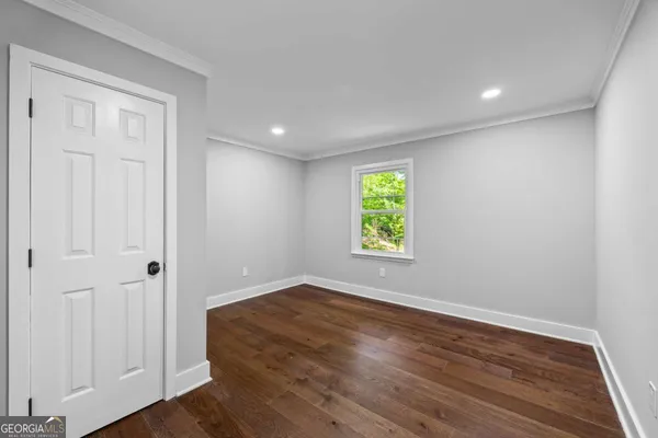 a spacious bedroom with a bed and a large window