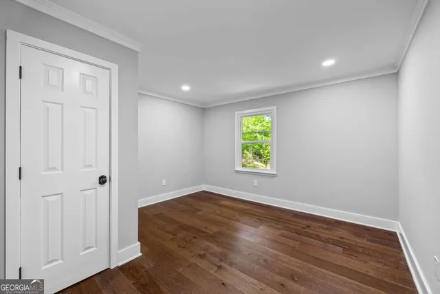 a spacious bedroom with a bed and a large window