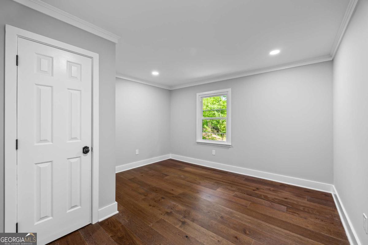 125 Terrell Drive Athens, GA 30606 - Photo 35 of 75 an empty room with wooden floor and a window