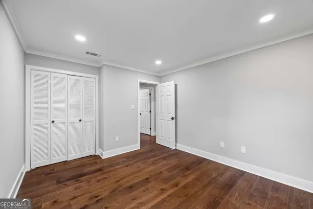 a living room with a bed furniture and next to a window