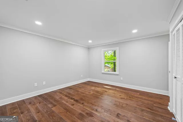 a view of a bedroom with a large bed and a window