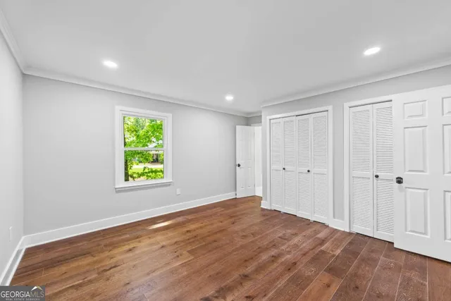 a view of walk in closet with empty racks
