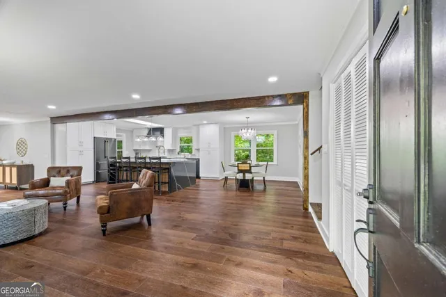 a living room with furniture and wooden floor