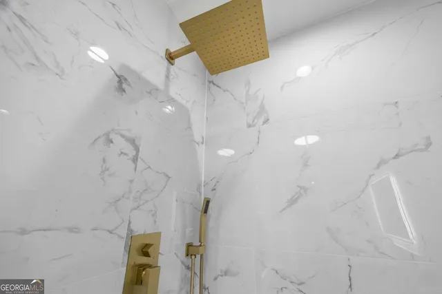 an aerial view of residential house with outdoor space and trees all around