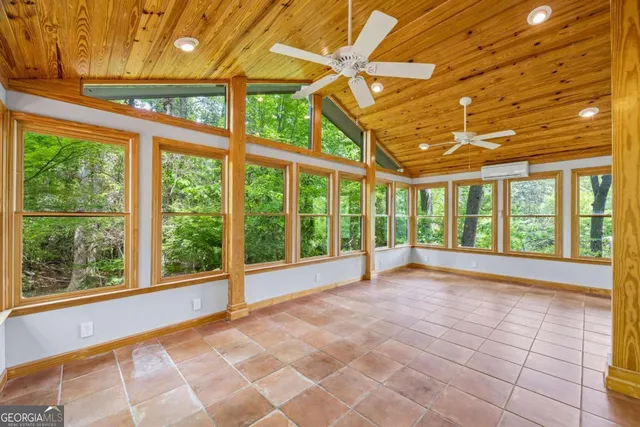 a view of a house with backyard and trees