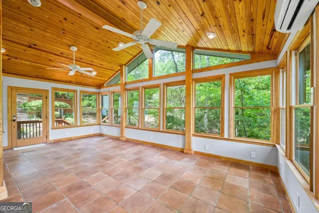 an aerial view of a house with a yard and a large tree