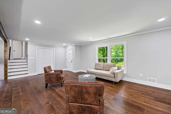 a view of a dining room with furniture window and wooden floor