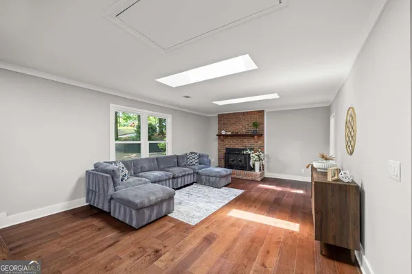 a view of a dining room with furniture a chandelier and wooden floor