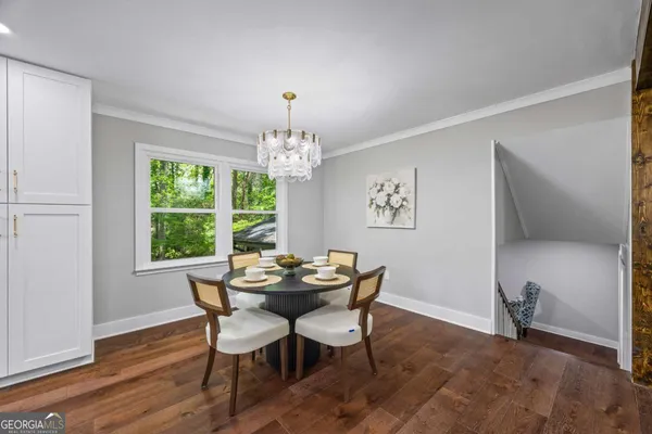 a view of a dining room with furniture and wooden floor