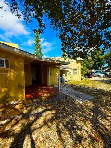 a view of a house with a tree