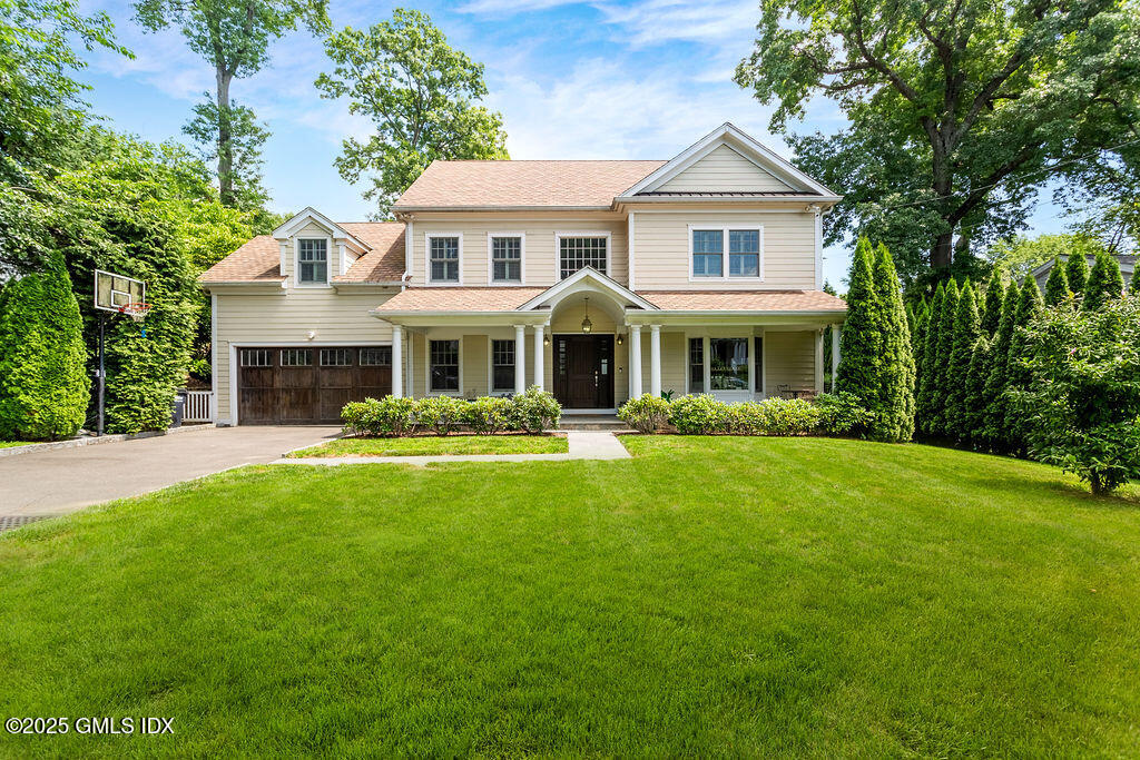 a front view of a house with a yard table and chairs