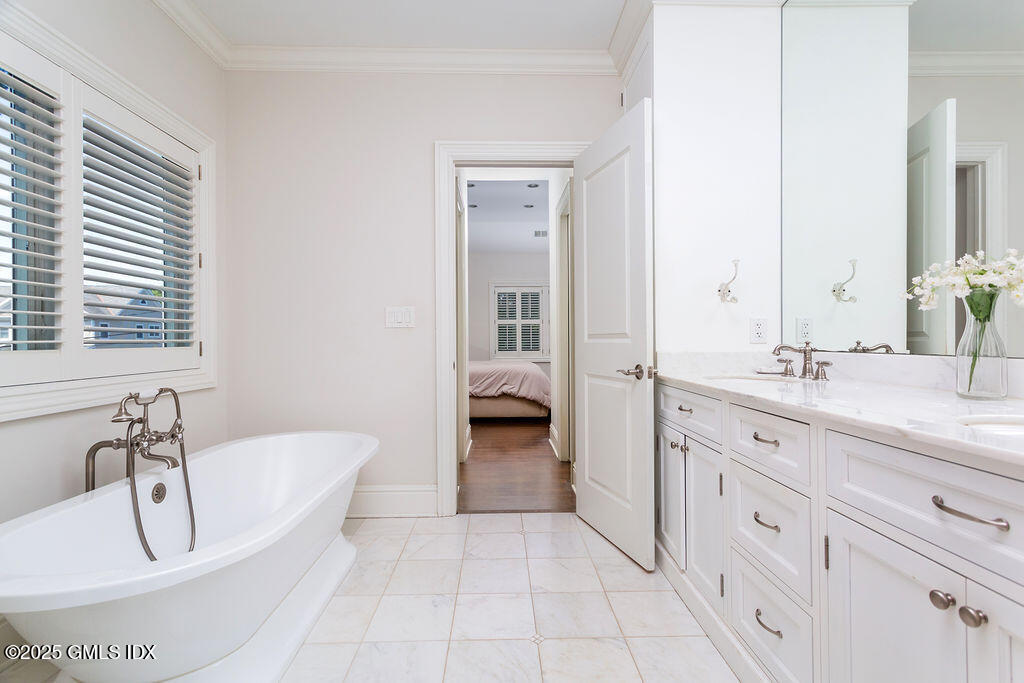 3 Elizabeth Lane Riverside, CT 06878 - Photo 19 of 39 a spacious en suite bathroom with a double vanity sink a mirror and a bathtub