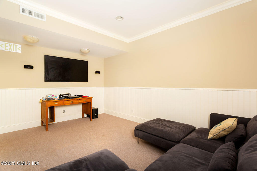 3 Elizabeth Lane Riverside, CT 06878 - Photo 32 of 39 a living room with furniture and a flat screen tv