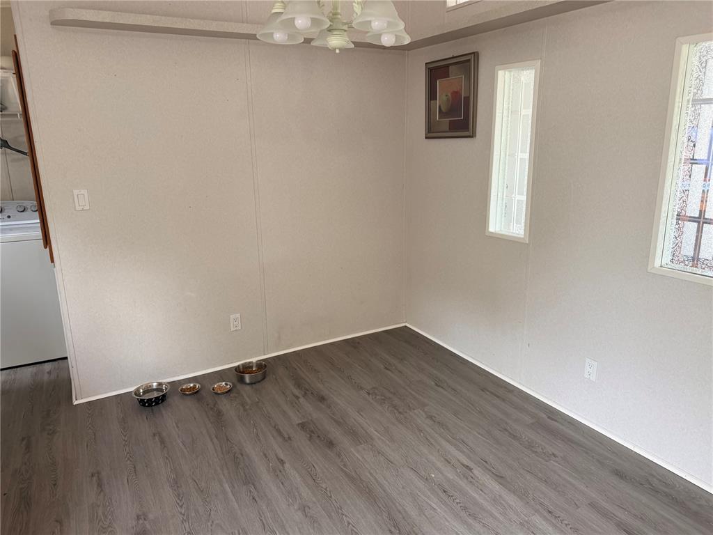 33 Ridge Road Frostproof, FL 33843 - Photo 6 of 21 an empty room with wooden floor and windows