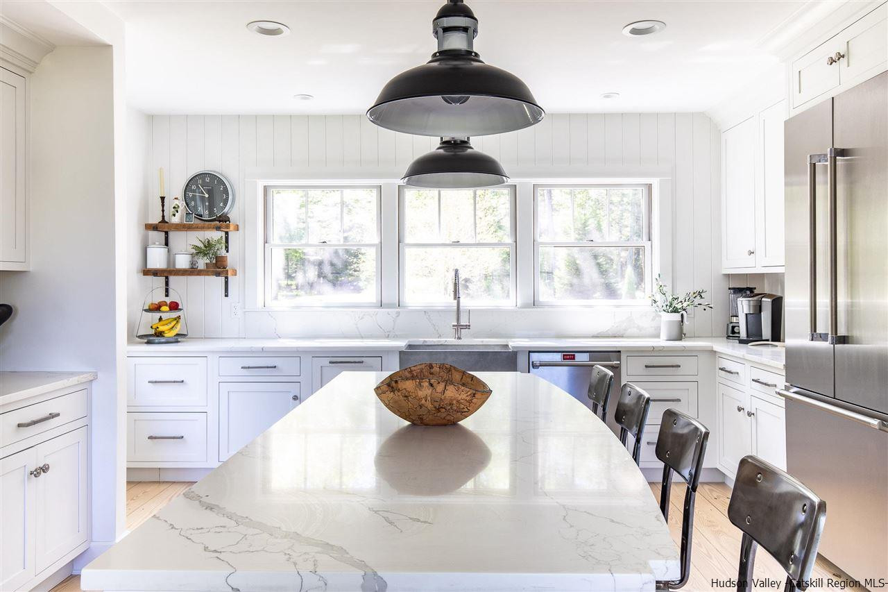 311 Buck Road Stone Ridge, NY 12484 - Photo 14 of 35 a kitchen with stainless steel appliances kitchen island granite countertop a stove a sink and a chandelier