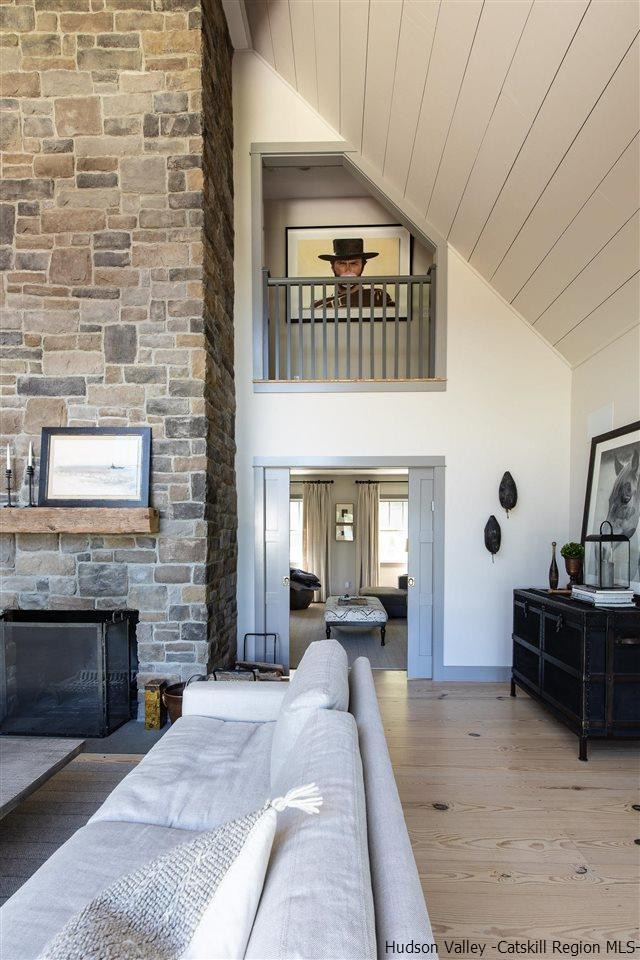 311 Buck Road Stone Ridge, NY 12484 - Photo 16 of 35 a living room with furniture and a fireplace