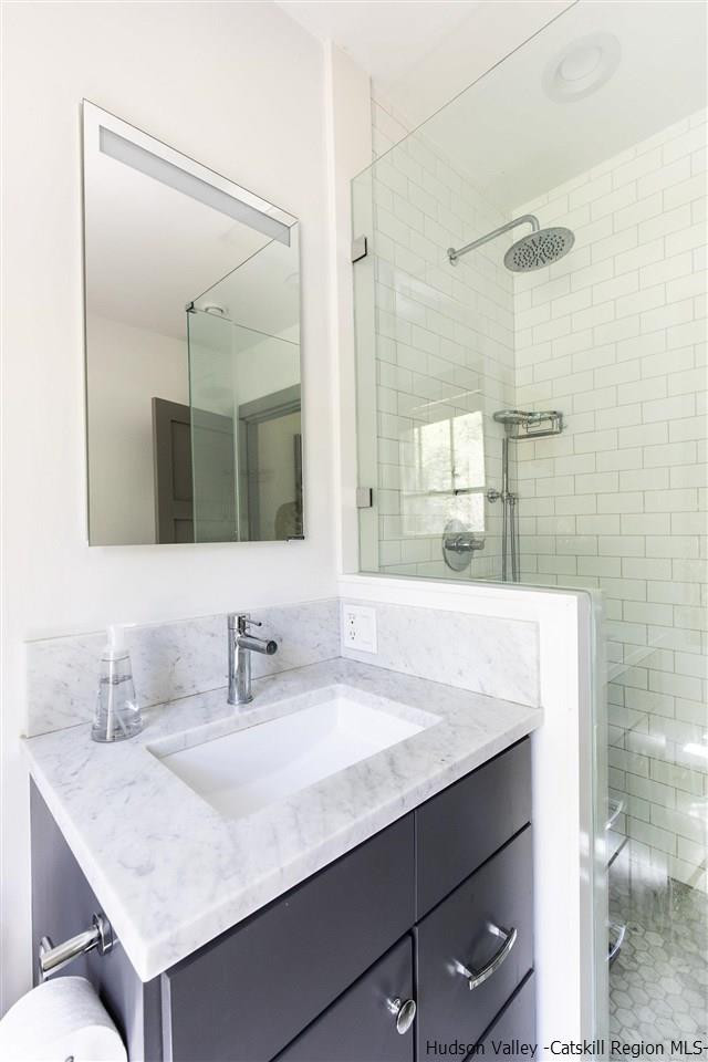 311 Buck Road Stone Ridge, NY 12484 - Photo 20 of 35 a bathroom with a sink and a mirror