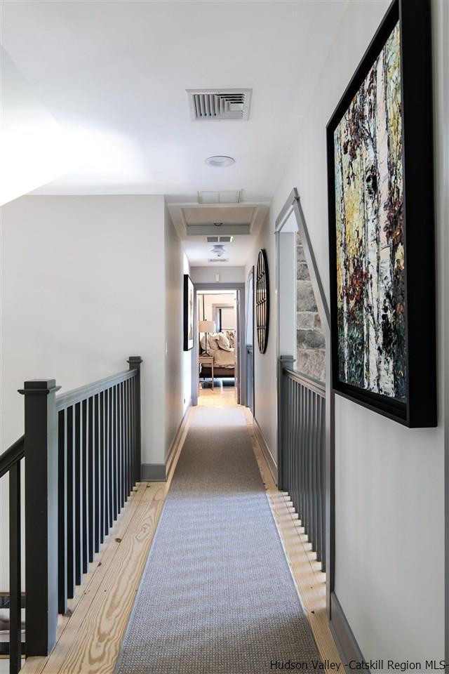 311 Buck Road Stone Ridge, NY 12484 - Photo 21 of 35 a view of a hallway with wooden floor and windows