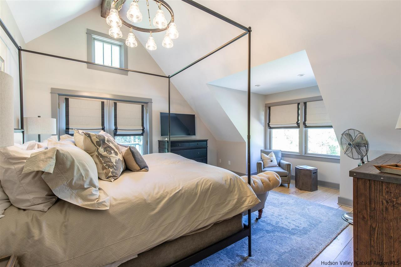 311 Buck Road Stone Ridge, NY 12484 - Photo 22 of 35 a bedroom with a bed and wooden floor