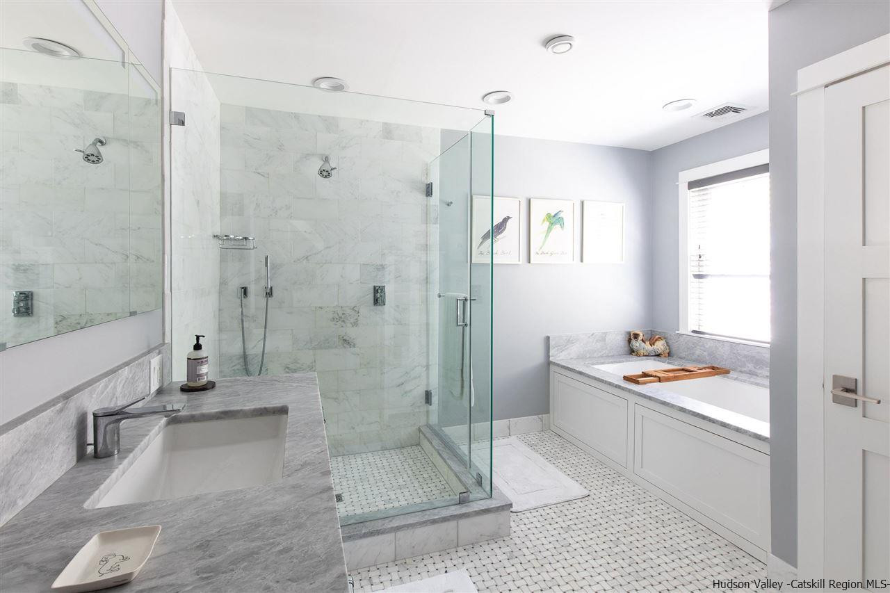 311 Buck Road Stone Ridge, NY 12484 - Photo 23 of 35 a bathroom with a tub shower sink and toilet