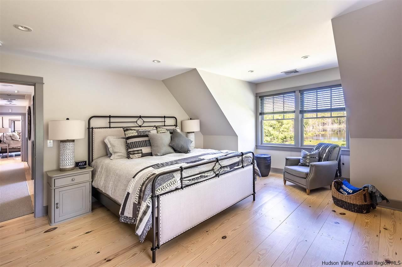 311 Buck Road Stone Ridge, NY 12484 - Photo 25 of 35 a bedroom with a bed and wooden floor