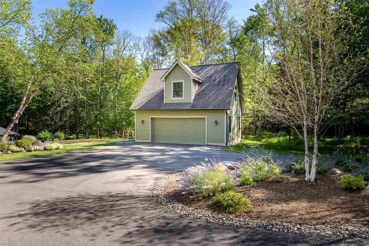 311 Buck Road Stone Ridge, NY 12484 - Photo 29 of 35 a front view of a house with a yard and garage