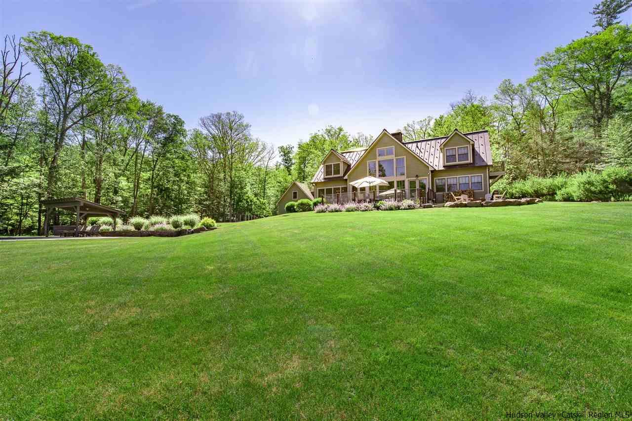 311 Buck Road Stone Ridge, NY 12484 - Photo 32 of 35 a front view of a house with a garden and trees