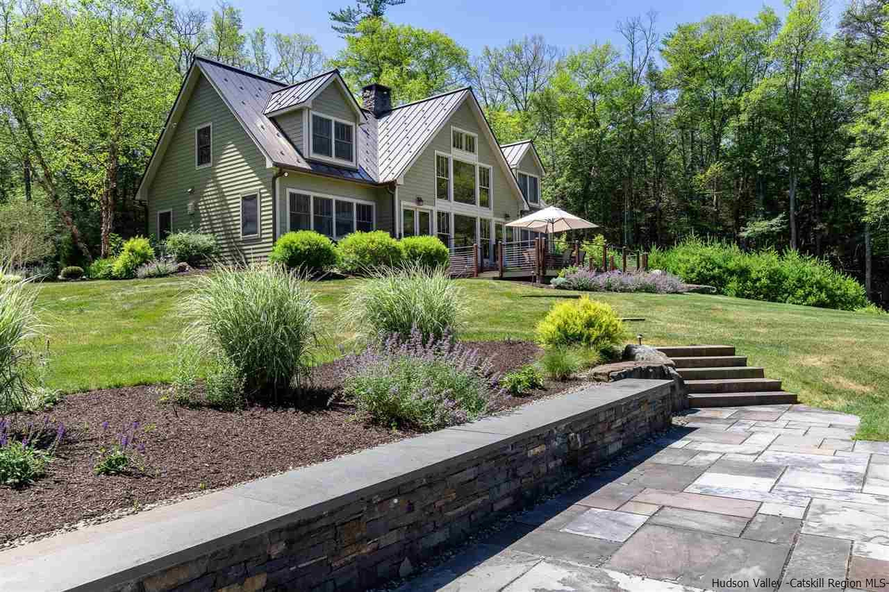 311 Buck Road Stone Ridge, NY 12484 - Photo 35 of 35 a front view of a house with a yard and potted plants