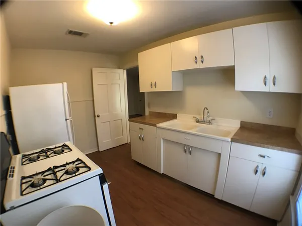 a kitchen with cabinets and white appliances