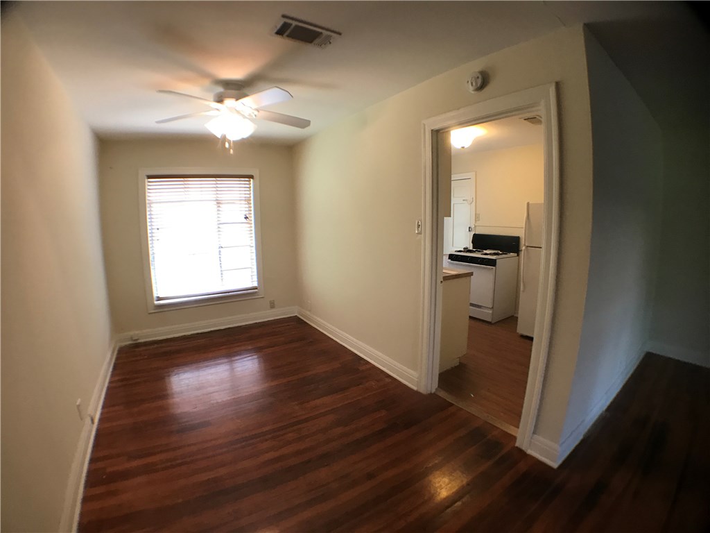 2509 Enfield Road, Unit A Austin, TX 78703 - Photo 4 of 8 an empty room with wooden floor closet and windows