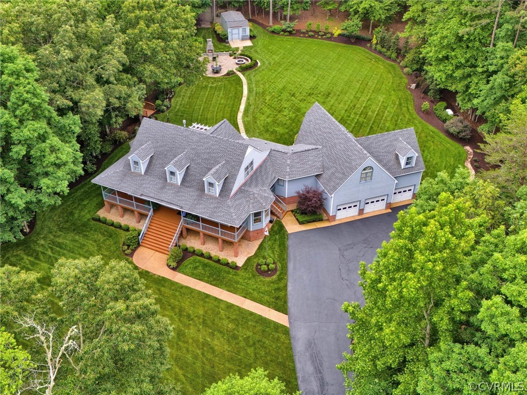 an aerial view of a house with garden space and street view