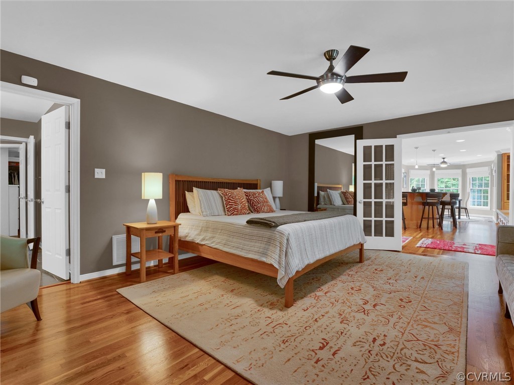 22341 Skinquarter Road Moseley, VA 23120 - Photo 13 of 50 a bedroom with a bed and a dresser with wooden floor