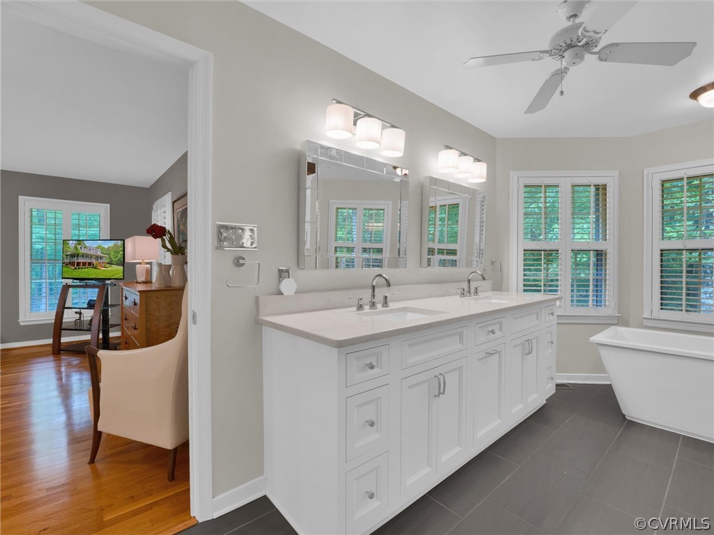 22341 Skinquarter Road Moseley, VA 23120 - Photo 14 of 50 a spacious bathroom with a double vanity sink a mirror and a bathtub