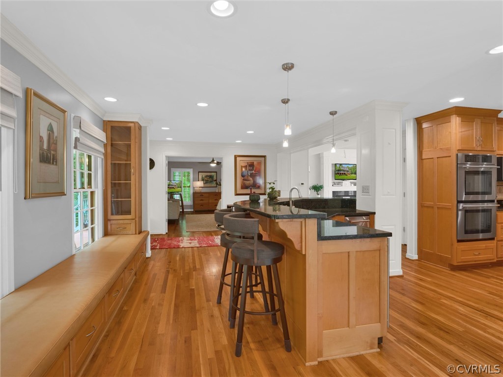 22341 Skinquarter Road Moseley, VA 23120 - Photo 23 of 50 a view of a kitchen with kitchen island stainless steel appliances wooden floor dining table and chairs