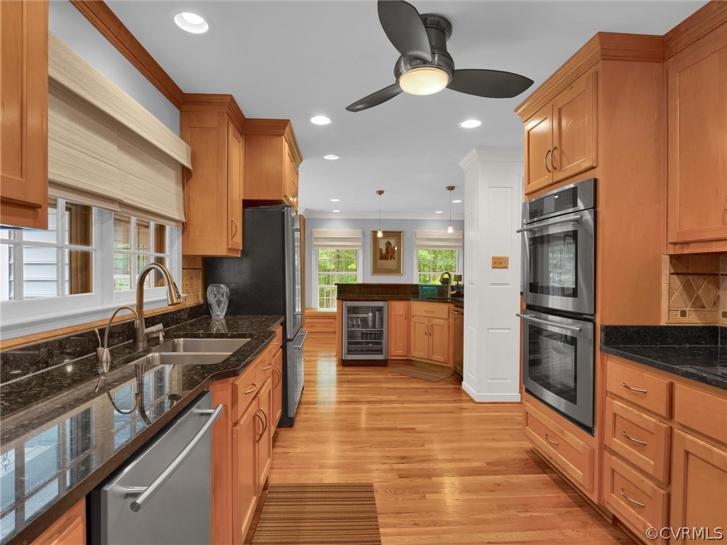 22341 Skinquarter Road Moseley, VA 23120 - Photo 25 of 50 a large kitchen with stainless steel appliances granite countertop a stove top oven a sink dishwasher a dining table and chairs with wooden floor