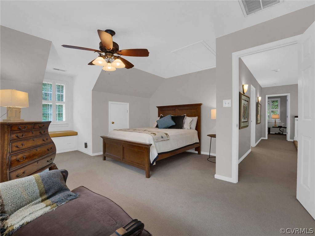 22341 Skinquarter Road Moseley, VA 23120 - Photo 36 of 50 a bedroom with a bed and a chandelier