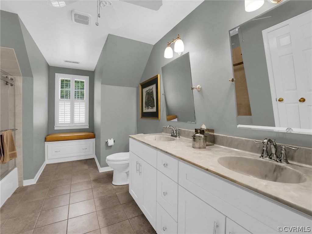 22341 Skinquarter Road Moseley, VA 23120 - Photo 37 of 50 a spacious bathroom with a granite countertop sink a toilet a mirror and bathtub