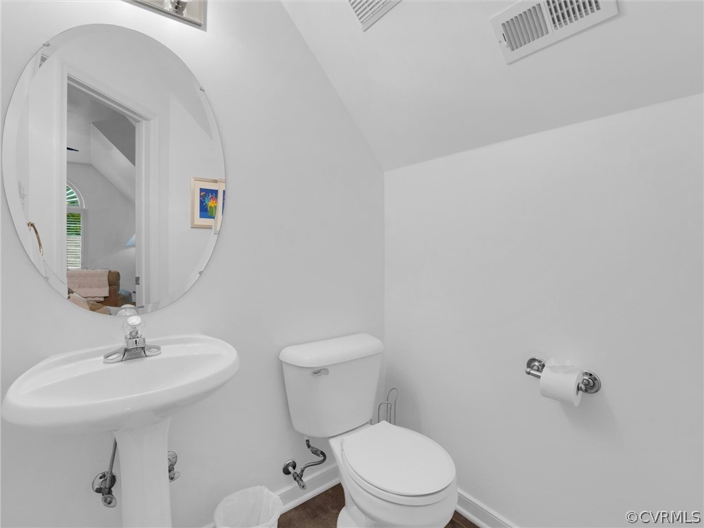 22341 Skinquarter Road Moseley, VA 23120 - Photo 45 of 50 a bathroom with a toilet a sink and mirror