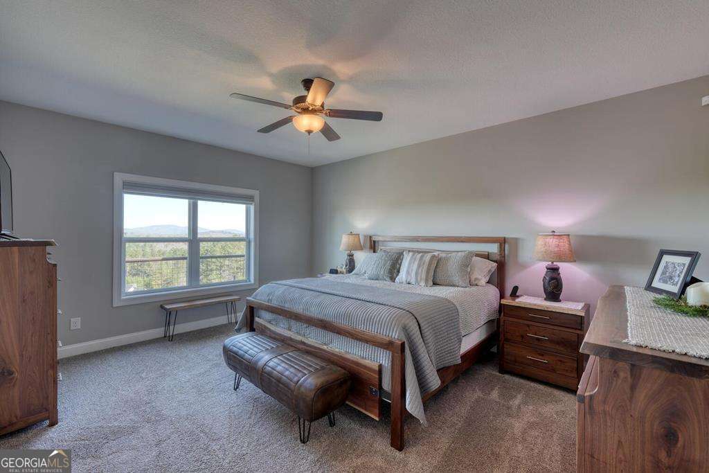 1309 Ridge Pointe Way, Unit 284 Blairsville, GA 30512 - Photo 22 of 75 a spacious bedroom with a bed and a chandelier