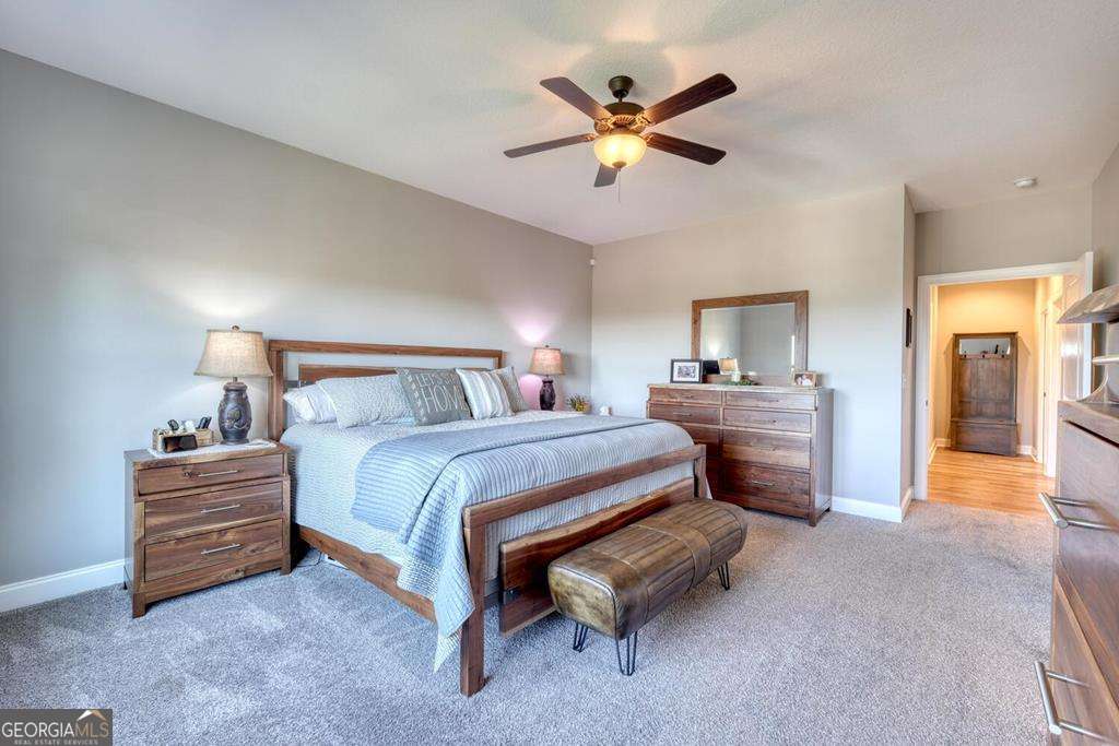 1309 Ridge Pointe Way, Unit 284 Blairsville, GA 30512 - Photo 24 of 75 a bedroom with a bed and a chandelier