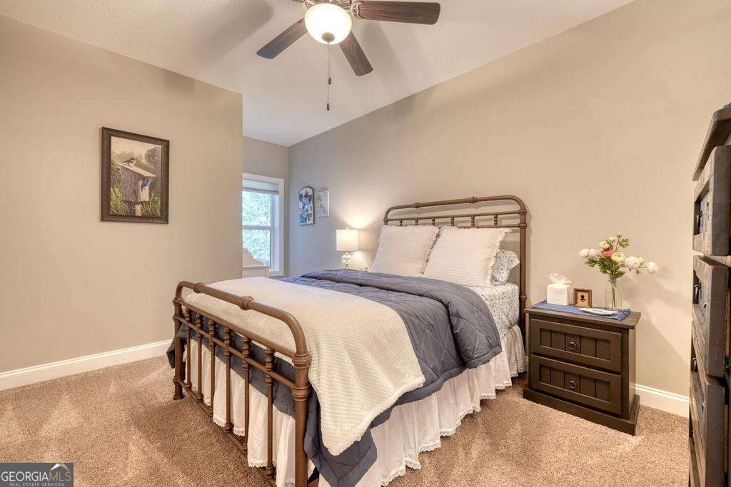 1309 Ridge Pointe Way, Unit 284 Blairsville, GA 30512 - Photo 28 of 75 a bedroom with a bed and a chandelier